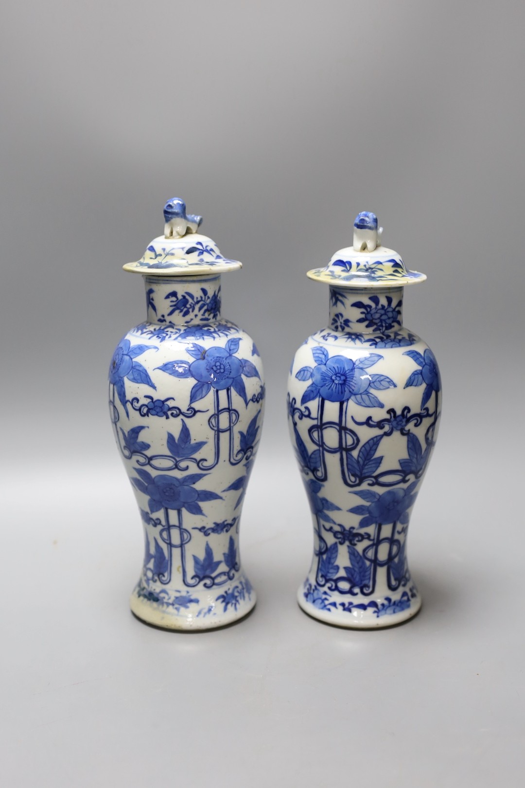 A pair of 19th century Chinese blue and white baluster jars and covers, 27cm